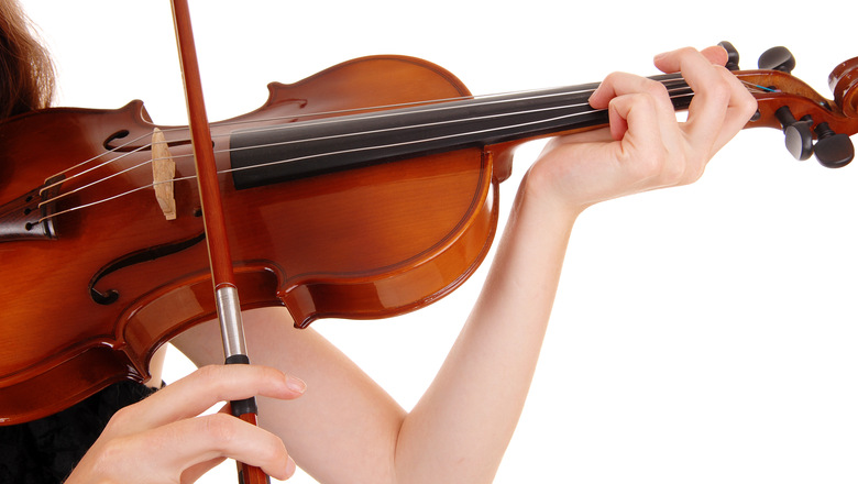 A closeup picture of a woman playing the violin, isolated for whitebackground.