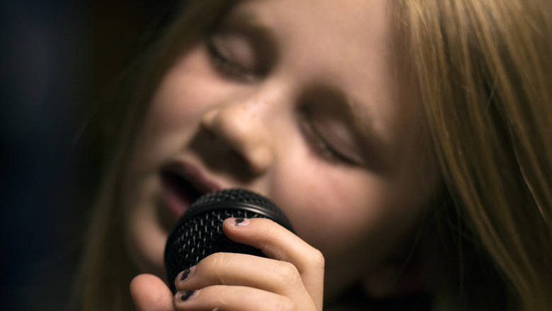 Girl holding microphone and singing