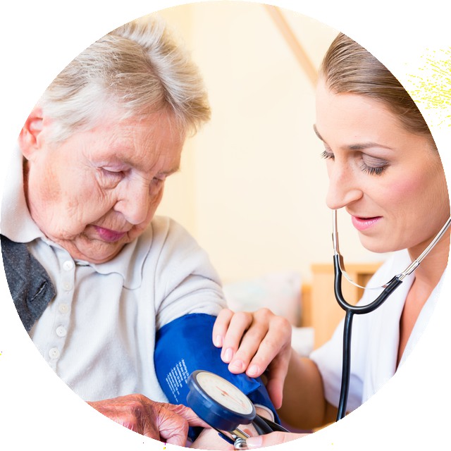Nurse measuring blood pressure at senior woman patient in retirement home